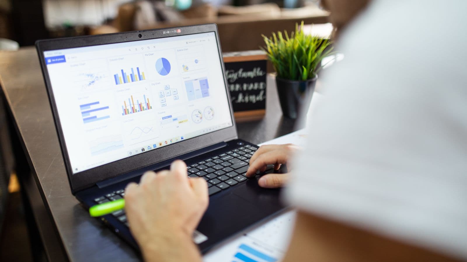 Blank spreadsheet template on laptop next to a printed OSHA form